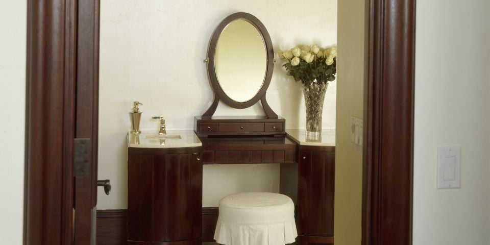 A dark, hardwood vanity located in a bathroom