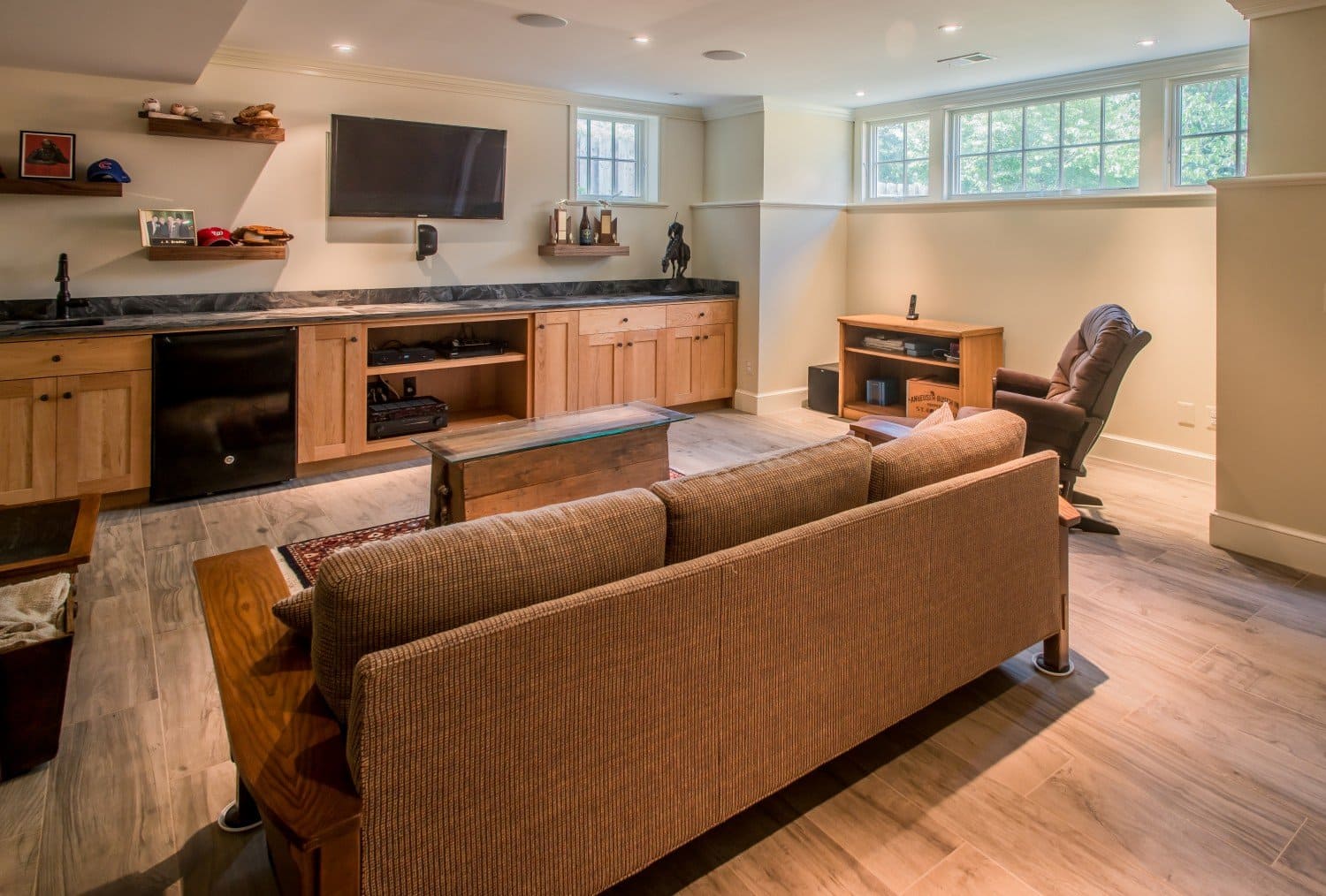 Basement Remodel Project Brings Basement Den Idea to Life with Natural LIght and Custom Built In TV Wall | Denny + Gardner Basement Remodeling Services