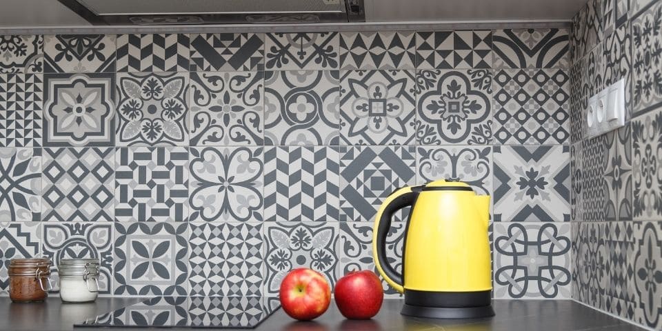 busy patterned black and white kitchen tile backsplash