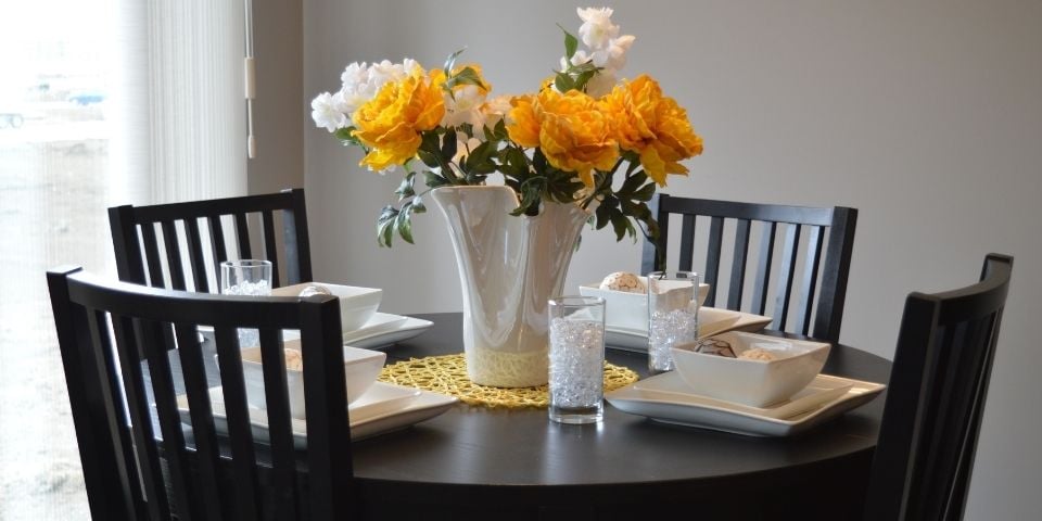 traditional dining table space with dark table and flowers in the center