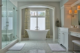 Bathroom Remodeling Services Luxury Bathroom with Freestanding Tub and Walk In Glass Shower with Large Window and Custom Cabinetry for Vanity Area | Denny + Gardner Design-Build Remodelers