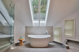 Bathroom Remodeling Services Freestanding Tub Natural Light Bathroom with Glass Walk In Shower and Staggered Windows | Denny + Gardner Design-Build Remodelers