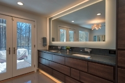 Bathroom Remodeling Services Modern Bathroom Design with Backlit Vanity Mirror and Custom Cabinetry  | Denny + Gardner Design-Build Remodelers