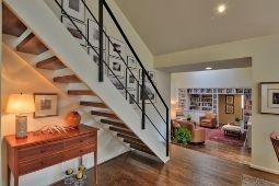 Interior Whole Home Remodel with Modern Stair Railing and Open Stairs with Step-Down into Living Area - Whole Home Remodeling Services | Denny + Gardner